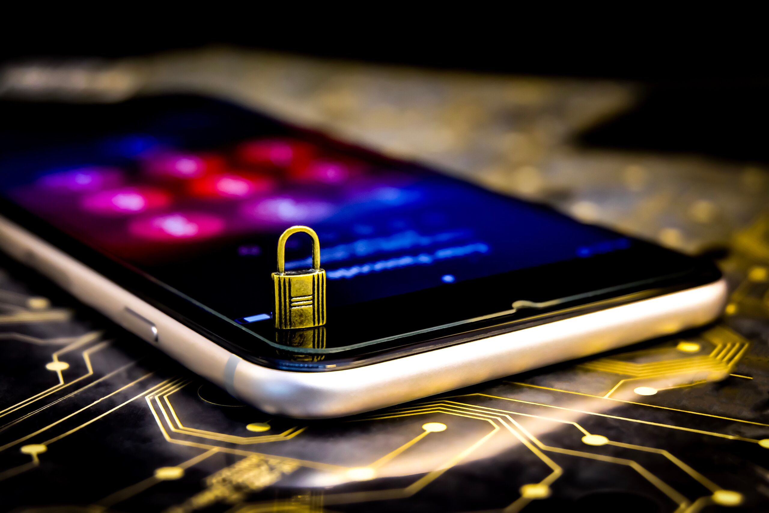 A lock sitting on a cell phone to signify cybersecurity and digital safety